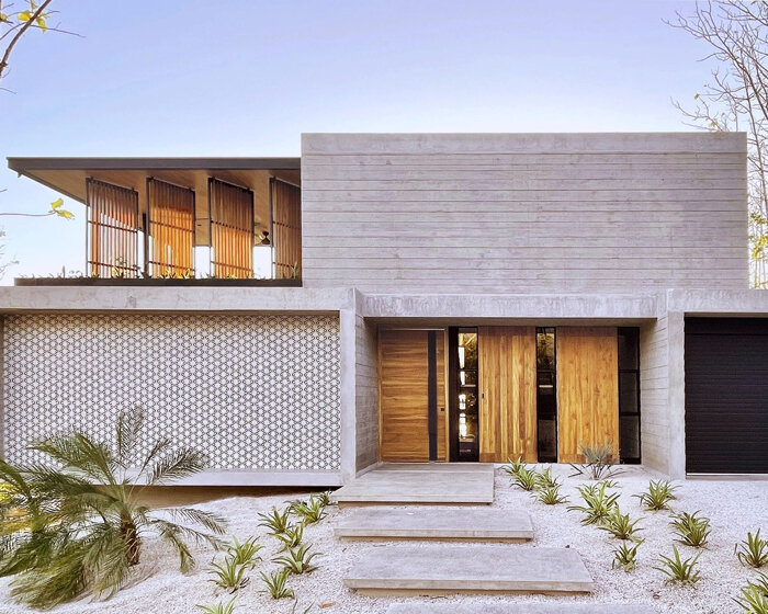 concrete residence's L-shaped infinity pool merges with costa rica's pacific coast