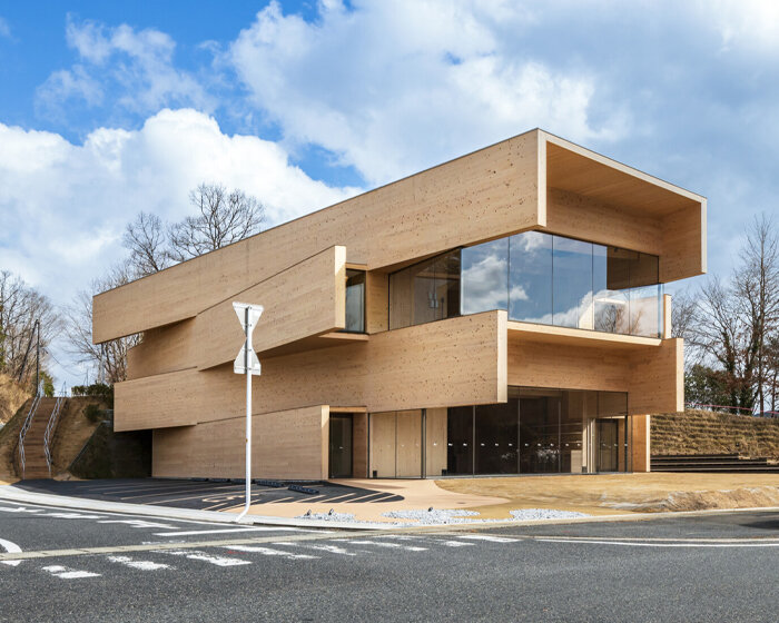 this japanese co-working space by kengo kuma combines protruding layers of CLT panels