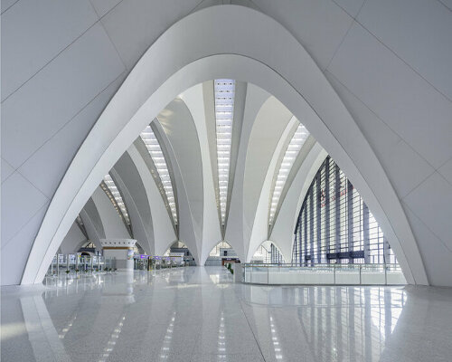 continuous white steel arch trusses form new nanchang east station's roof wings