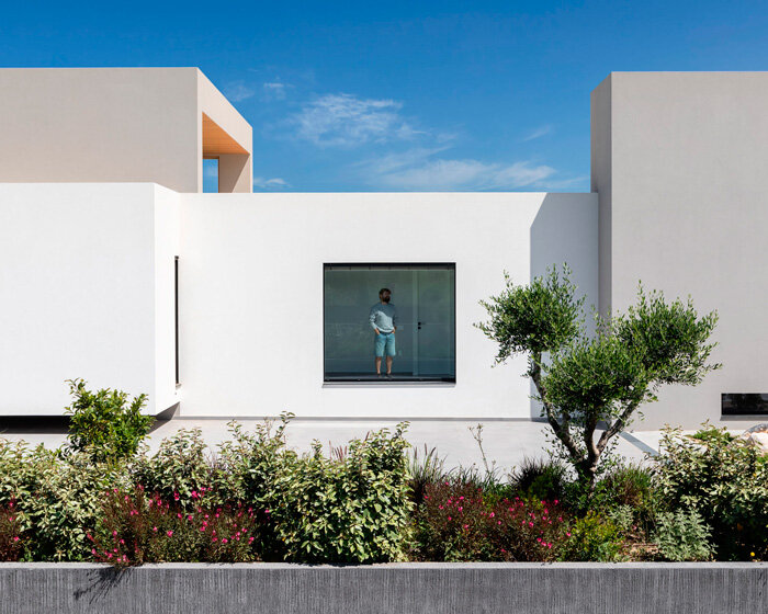 interior and exterior merge within façade studio's geometric panorama residence in greece