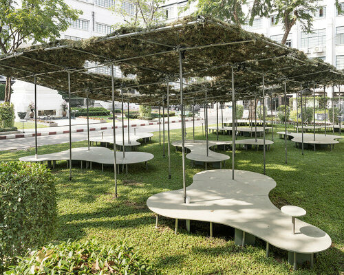 people pavilion's decomposed grass canopy shades over free-form circular seating