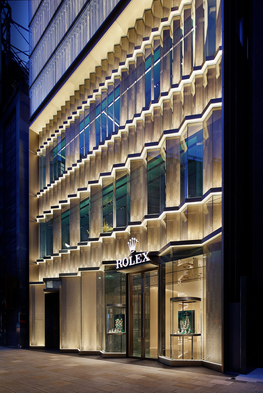 curiosity envelops rolex's ginza flagship in a double bezel pattern