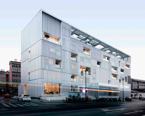 punched aluminum plates fold corrugated facade around TAOA's arts center in china