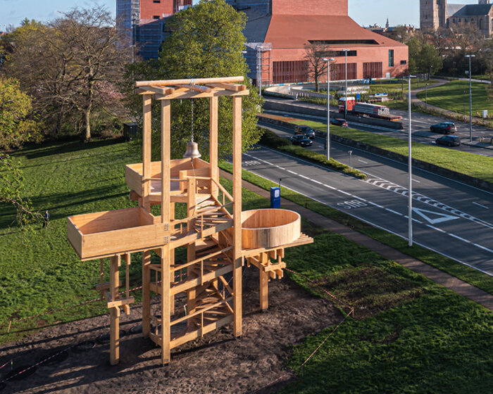 wooden 'tower of balance' by boonserm premthada emits ancient bell sounds across bruges