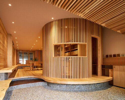 wooden louvers run along kyoto office space's entire interior by ujizono architects