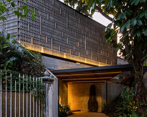 concrete breezeblocks clad residence's facade by wiyoga nurdiansyah architects