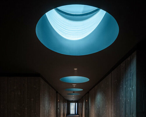 yod group embeds portholes looking into steel pool within hay boutique hotel's corridors