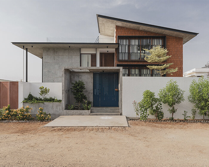 modern farmhouse in india sets up patterned exposed brick facade