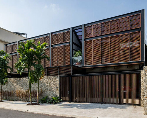 a+ architects' ecobreeze house self-breaths through wooden double-skin facade in vietnam