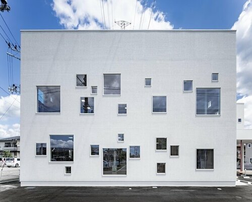 multi-sized square windows compose welfare facility's dynamic facade in japan