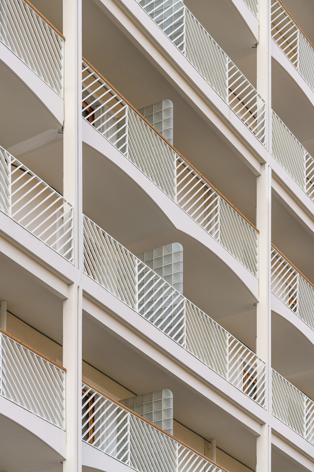 matte terracotta tiles in dynamic patterns outline athletes' village in ...