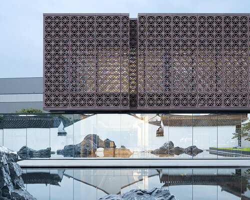 red latticed facade wraps renovated jiemin library by UAD within cai yuanpei square in china