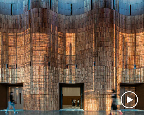 undulating wooden panels form veil-like facade in vietnamese conference center