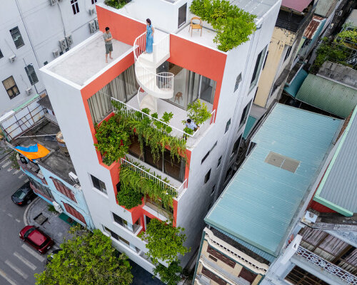 a respiratory atrium lined with greenery runs through d15studio's townhouse in vietnam