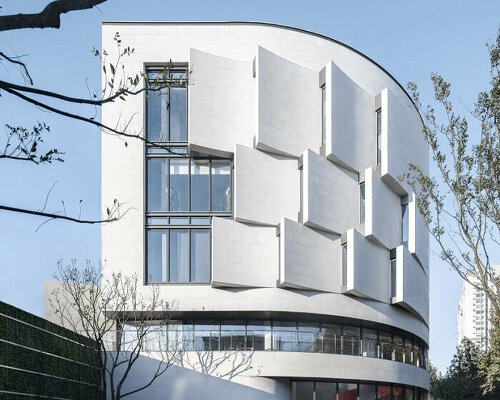 staggered reverse arc facade wraps jiangpu community culture and sports center in shanghai