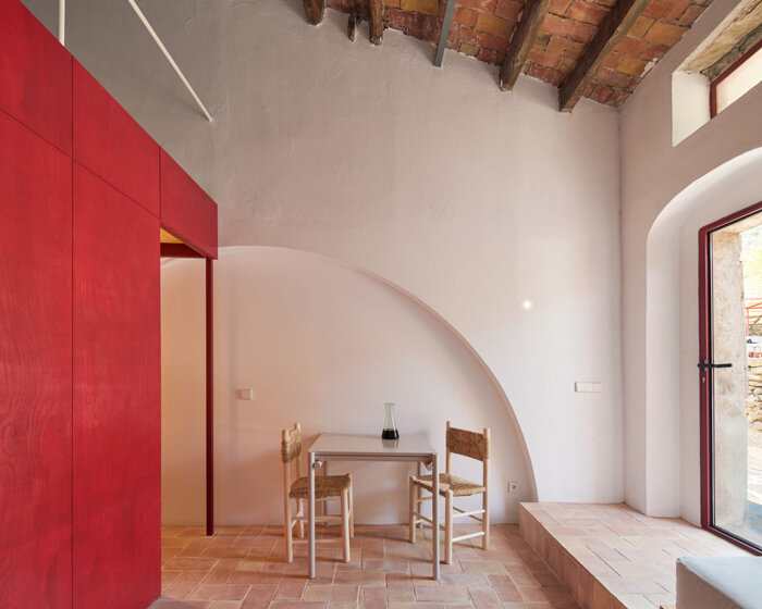 mas estela: rai pinto studio transforms catalan winery into red-infused holiday home