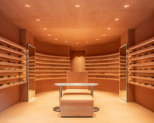 monochromatic terracotta interiors by el departamento adorn new optical boutique in spain