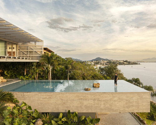 with a suspended infinity pool, tetro's ponte house hangs from the hillside on brazilian island