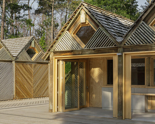 patterned repurposed timber panels clad grande dune du pilat visitor center's huts in france