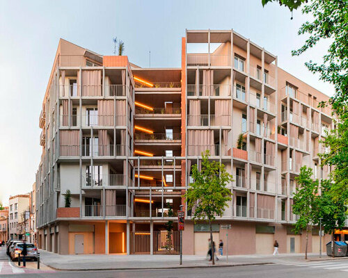 multi-level residential corner building in barcelona boasts open green courtyard