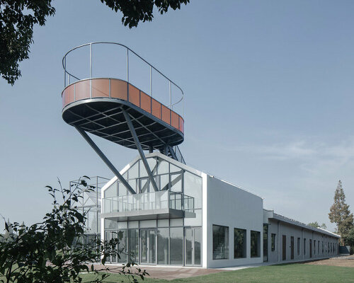 bright orange glass fencing encircles revitalized warehouse's rooftop observatory in shanghai