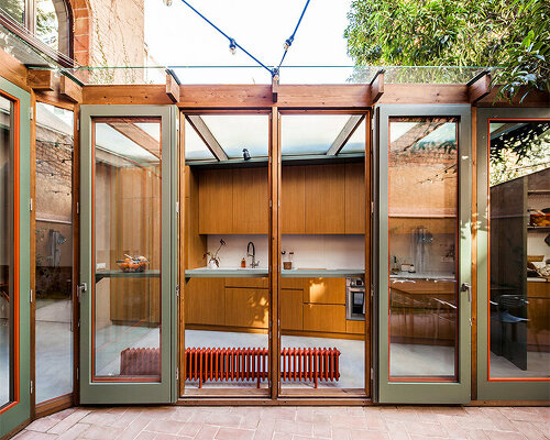 anna & eugeni bach's transparent greenhouse extension bathes barcelona dwelling in light