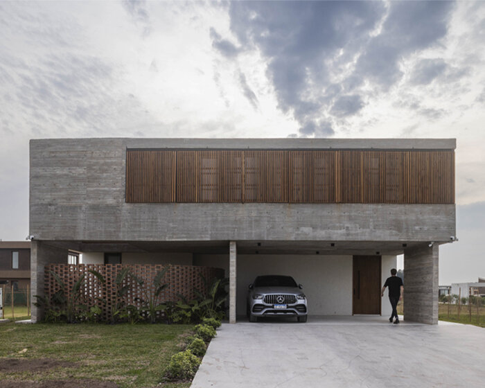 adjustable sunshades animate rustic facade in argentine residence by TIM arquitectos