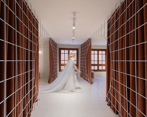 bridal catwalk meets flexible fitting rooms in terracotta-hued spanish store by L'AURA ORTÍN