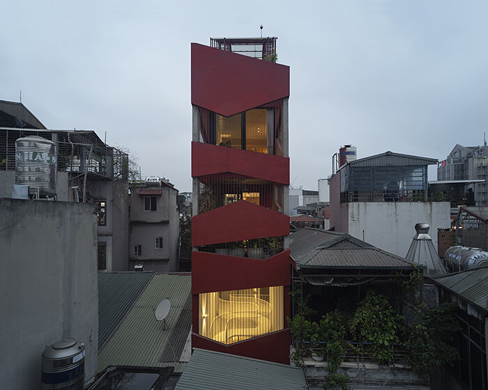 red facade by nghia-architect reflects hanoi’s urban contours through ramdomized patches