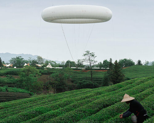 floating cloud-like ring by line+ studio hovers over tea fields in chinese village