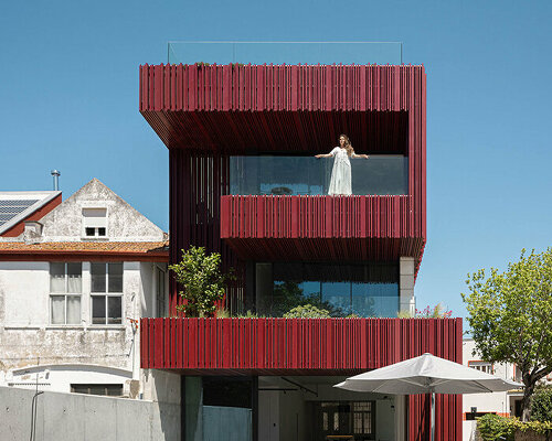 red timber-clad skin embraces park house's art nouveau facade in aveiro