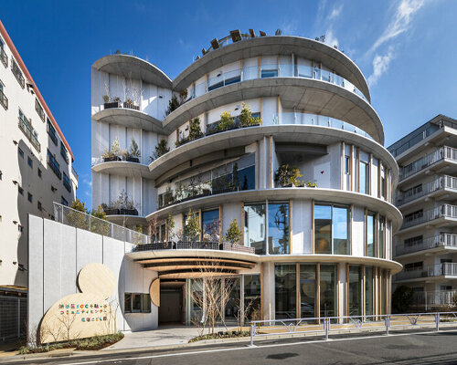 circular slabs wrap around kengo kuma's civic complex in shibuya, tokyo