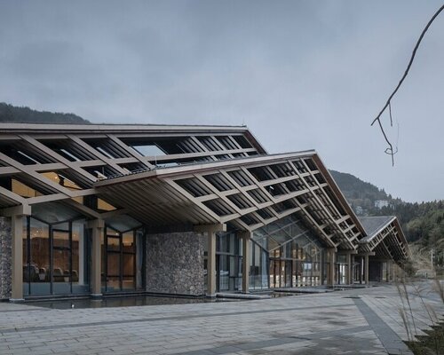 cascading folding roof of GLA design's community center in china echoes mountain contours