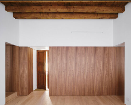 wooden surfaces embrace renovated apartment by cntextual in italian courtyard building