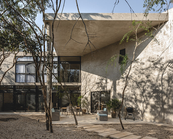 concrete residence with integrated yoga studio weaves around yucatan's endemic trees