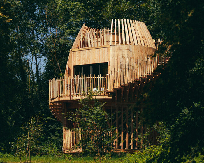 AW2's four wooden cabins emerge amid treetops like blossoming buds in france