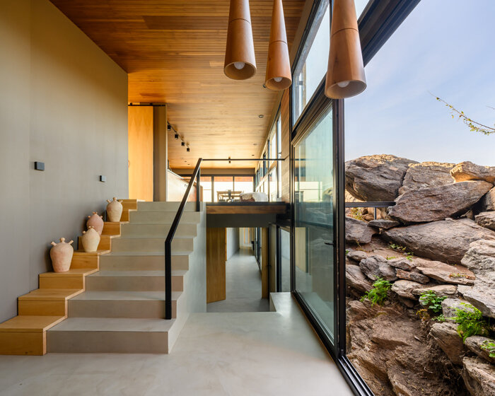 casa en piedras: estudio palacios nests modern home among large stones in argentina