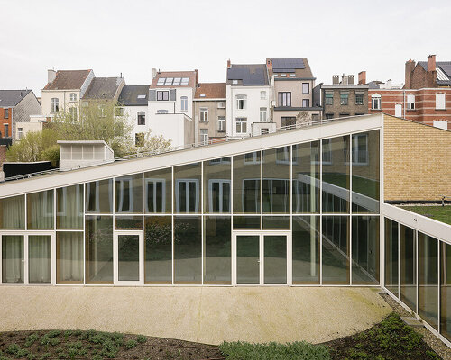 evr-architecten's new brick-clad office building envelops glazed green patio in belgium