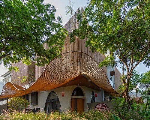 undulating steel canopy protects lumintu house from sunlight in north jakarta