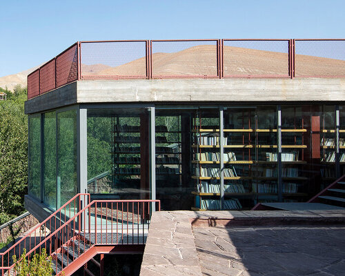 suspended bookshelves float within villa's glazed volume by ayeneh office in tehran