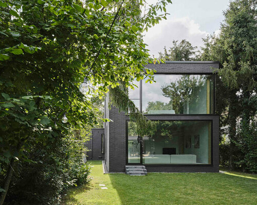 glazed openings punctuate tiefes haus' dark brick facade in germany