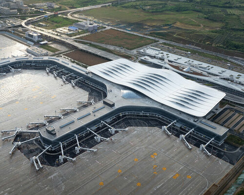 aedas' rippling terminal for yantai penglai airport echoes nearby mountainscape