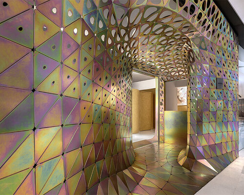 thousands of galvanized steel petals shape prismatic installation within gallery in shanghai