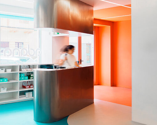 curved stainless steel counter in adana dental clinic reflects bold colors and shapes