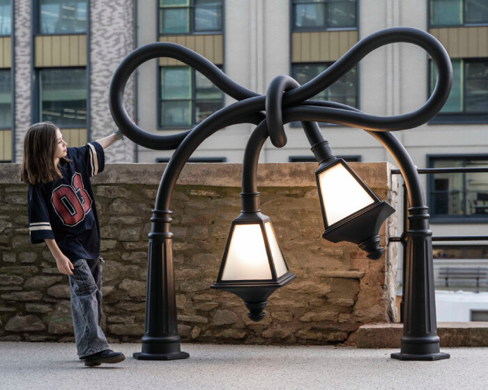 alex chinneck knots street lamps and twists a phone booth for his assembly bristol sculptures