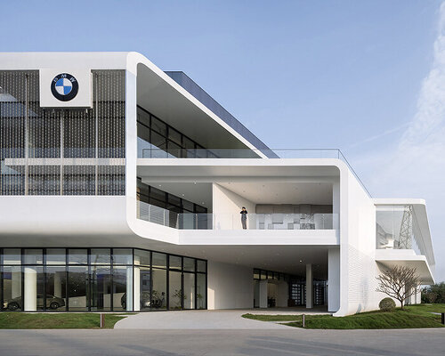 metallic lattice screen envelops BMW foshan baochuang center's facade in china