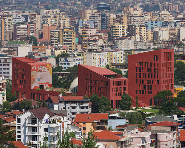 oppenheim architecture reveals tirana’s college of europe campus as red concrete cluster