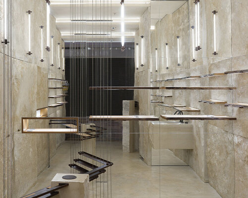 quarries inspire adjustable shelving system in dongqi design's stone-clad shanghai store