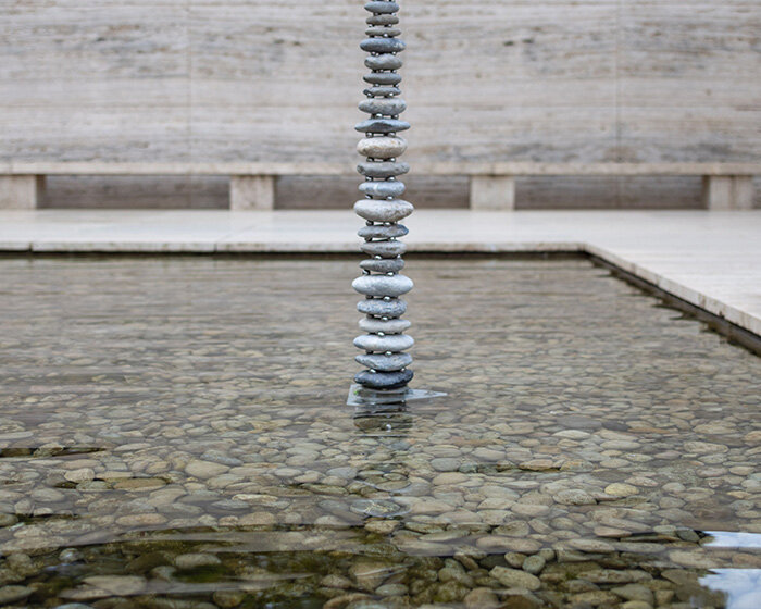 levitating pebble installation defies gravity at mies van der rohe's barcelona pavilion