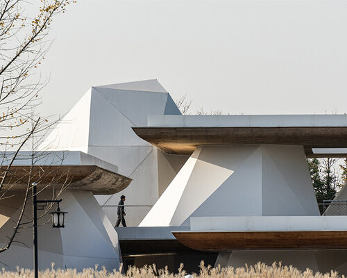 twelve rock-like tents by line+ brace layered steel platforms floating above mountains